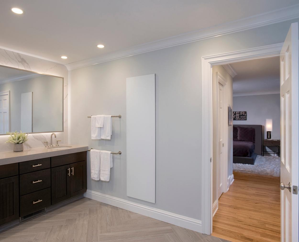 master bedroom can be seen through the door of this well designed master bedroom suite