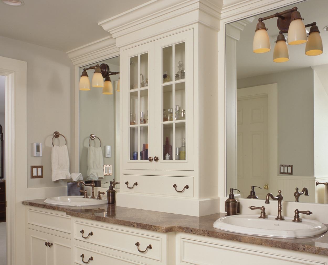 Double vanities with a wall unit in between.