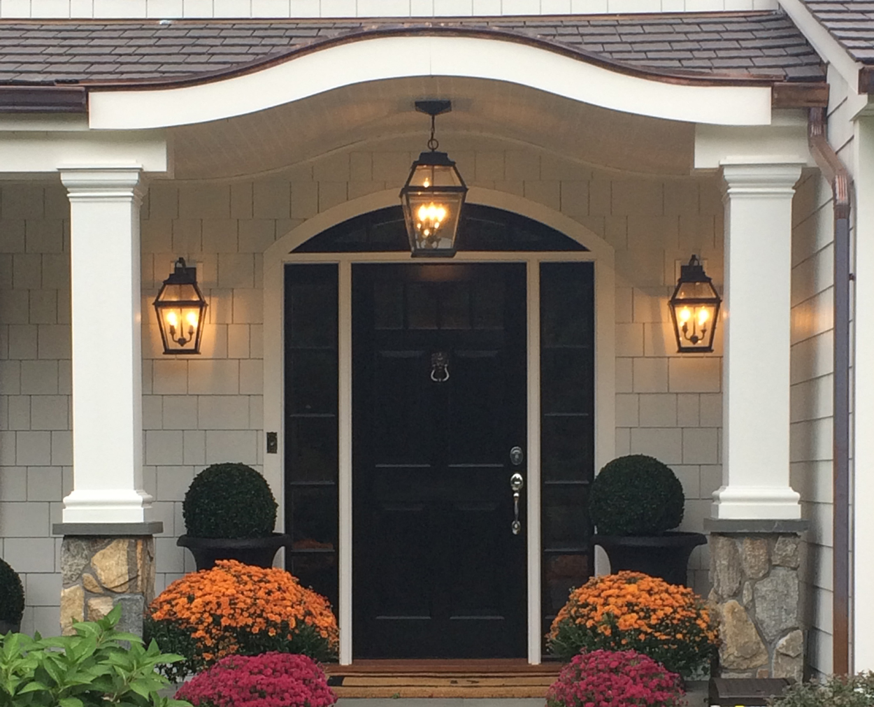 Black front door with columns and stone bases