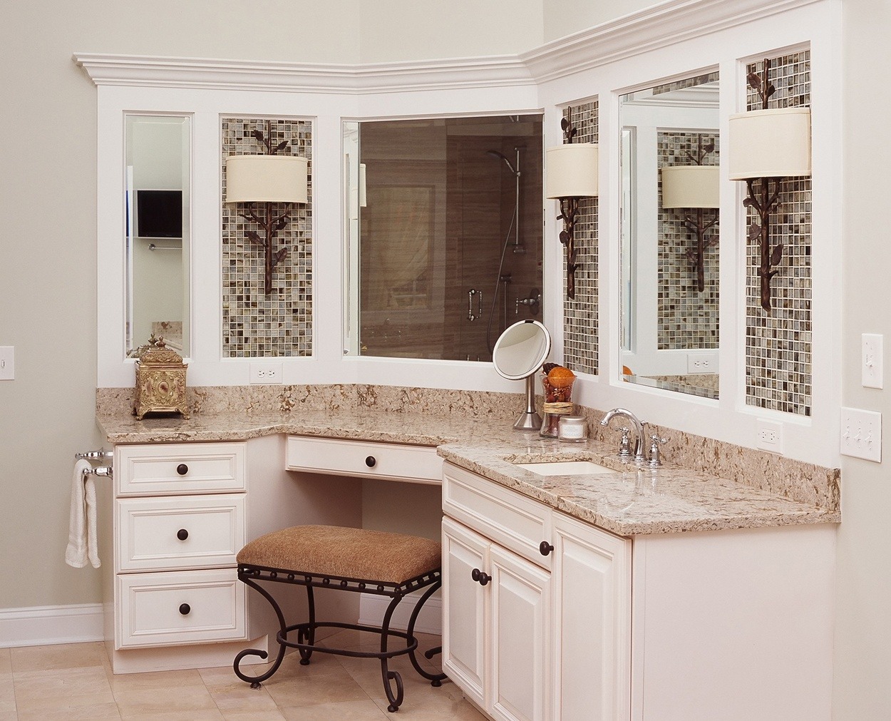 Custom cabinetry with detailing around mirrors coordinates with free standing tub details.