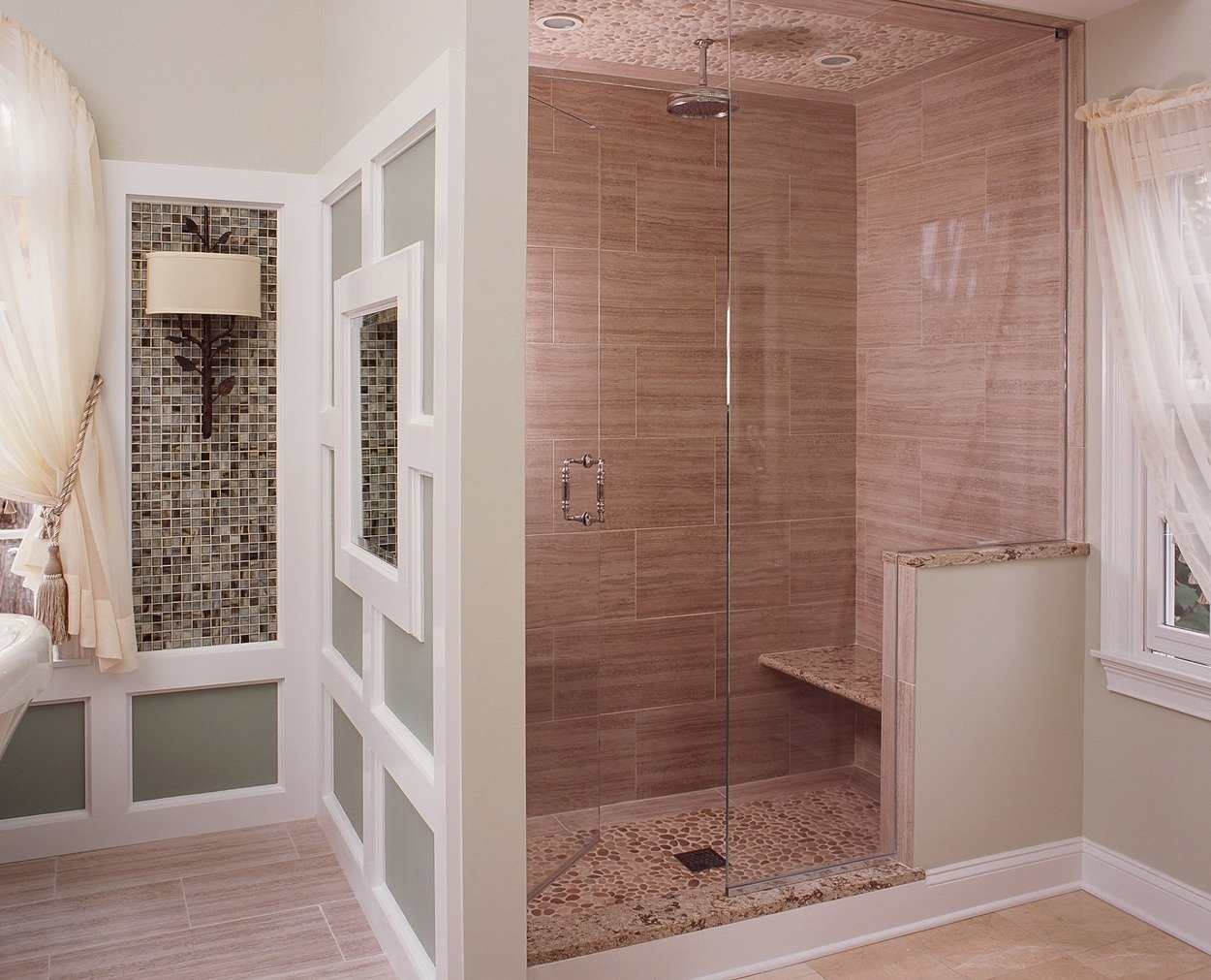 Stone pattern reflects on the floor and ceiling in this frameless shower.