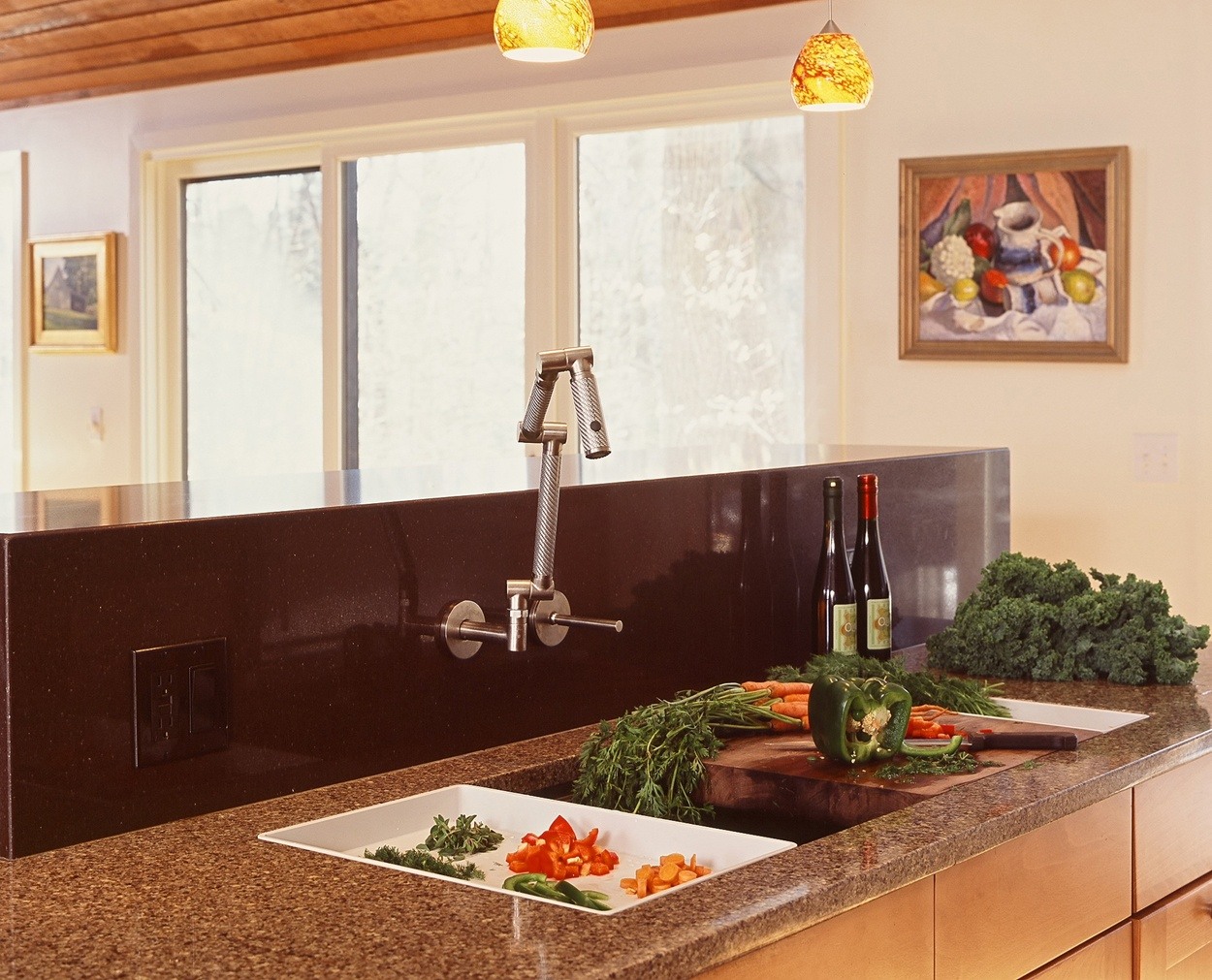 Large sink with a waterfall counter on a bi-level island.