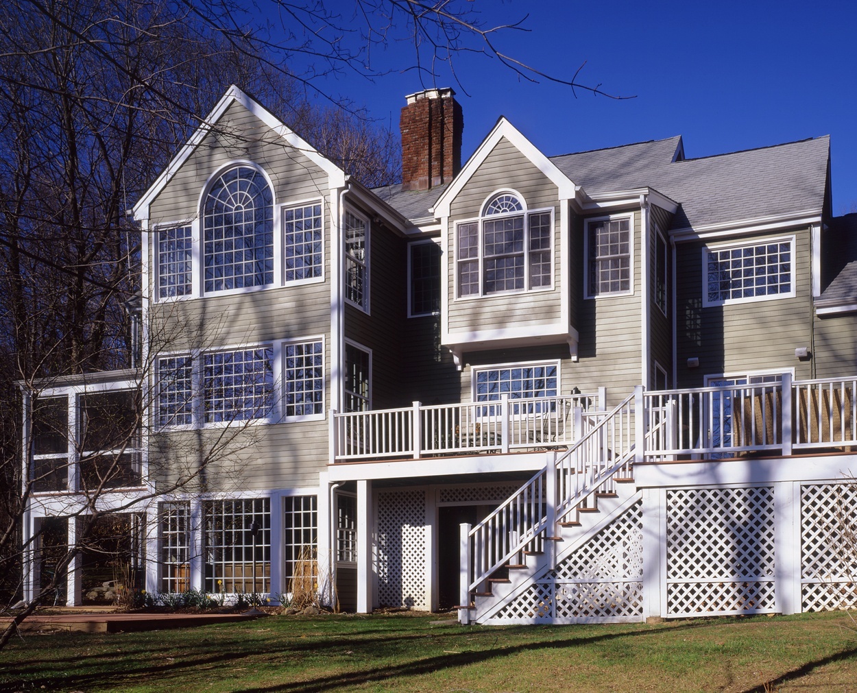 Side by side kitchen and master suite additions extend the back  of this Wilton CT  home.